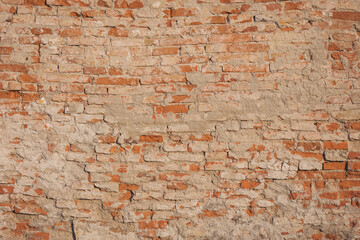 Empty Old Brick Wall Texture. Painted Distressed Wall Surface. Grungy Wide Brickwall. Grunge Red Stonewall Background. Shabby Building Facade With Damaged Plaster. Abstract Web Banner. Copy Space.