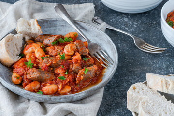Beef chipolatas and bean casserole with crusty bread