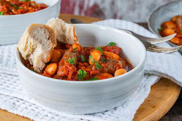 Beef chipolatas and bean casserole with crusty bread