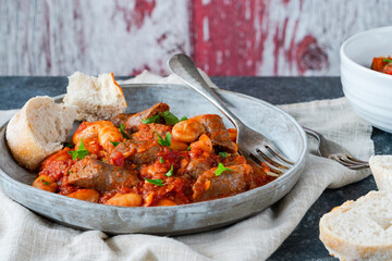 Beef chipolatas and bean casserole with crusty bread