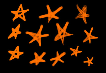 Fototapeta na wymiar Collection of graffiti street art tags with star symbols in orange color on black background