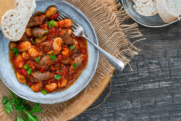 Beef chipolatas and bean casserole with crusty bread