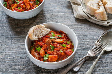 Beef chipolatas and bean casserole with crusty bread