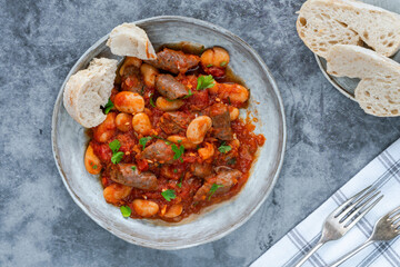 Beef chipolatas and bean casserole with crusty bread