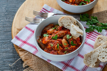 Beef chipolatas and bean casserole with crusty bread