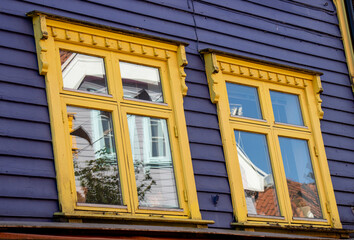 Stavanger, windows with their reflections in one of the brightly colored houses, blue and yellow, on Øvre Holmegate street or Fargegaten