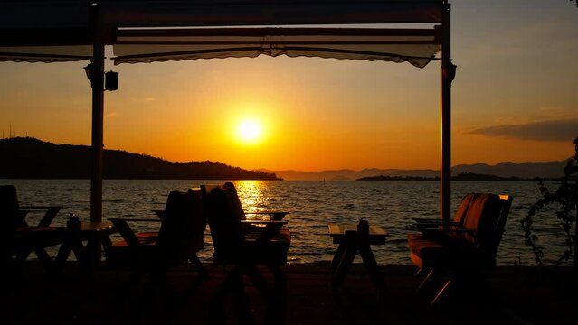 Seaside empty cafe at sunset.