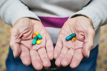 Hands holding colorful pills