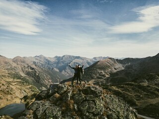 a couple of people standing on top of a mountain above mountains: Andorra, Pyrenees