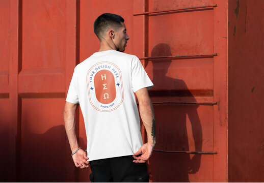 Mockup of man wearing customizable t-shirt by ladder, rear view