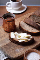 a loaf of black bread cut into pieces. Rye bread with butter.