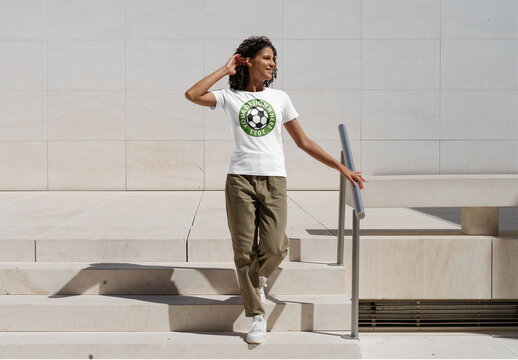 Mockup of woman wearing customizable t-shirt on urban steps