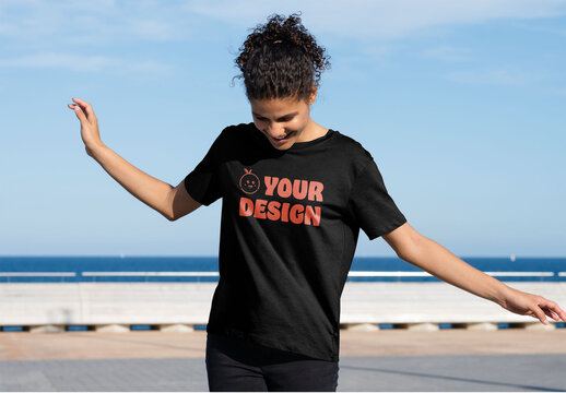 Mockup of carefree woman wearing customizable t-shirt, arms out