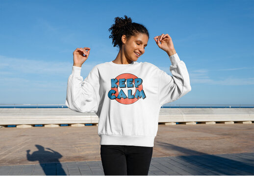 Mockup of woman wearing customizable sweatshirt with arms up, smiling