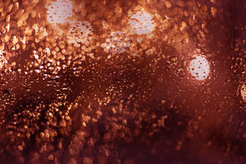 Blurred background with raindrops and lights.