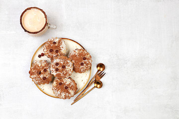 Chocolate muffins with nutmeg and cinnamon eggnog on a concrete background, cozy breakfast concept, advertising for a cafe or bakery. Warming egg drink in cold season with delicious dessert,