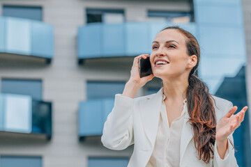 portrait of businesswoman talking on mobile phone on the street