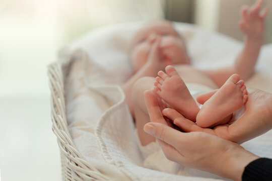 cute heels of a baby lying in a cradle, small feet of a newborn baby, IVF, maternity leave