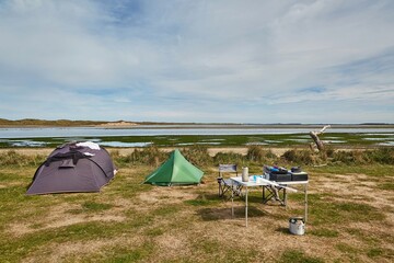 Tents for camping on the shore of a sea bay