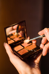 Makeup brush, the secret to perfect eyeshadow application, makeup brushes and a large beautiful golden powder compact