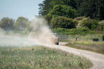 British army FV4034 Challenger 2 ii main battle tank throwing up clouds of dust on a military exercise, Wiltshire UK