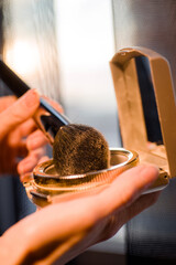Makeup brush, the secret to perfect eyeshadow application, makeup brushes and a large beautiful golden powder compact