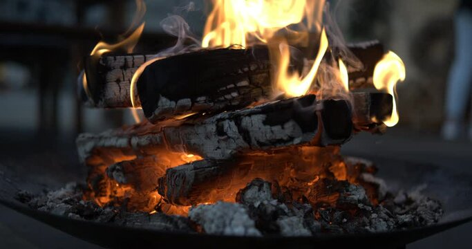 Close-up of wood burning inside bonfire captured in super slow-motion at 800 fps, ember glow fire flames