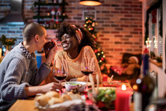 Intimate Holiday Dinner with a Loving Lesbian Couple Enjoying Wine