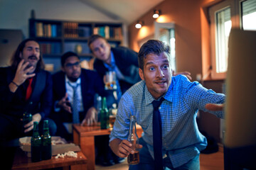 Businessmen sport fans watching game at home
