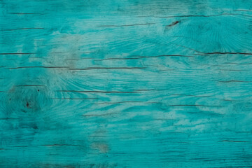 A textured turquoise wooden surface with natural grain patterns and rustic charm