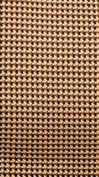 A tan and khaki houndstooth pattern with an oval motif in the middle