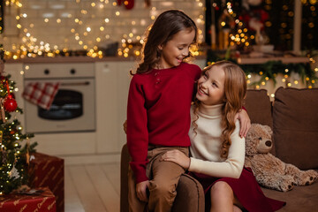 teenage sisters twins at home in the kitchen waiting for the New Year