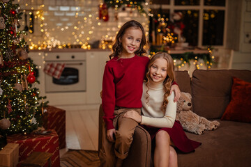  teenage sisters twins at home in the kitchen waiting for the New Year