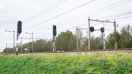 Fototapeta premium Signal poles along a railway track set to red 