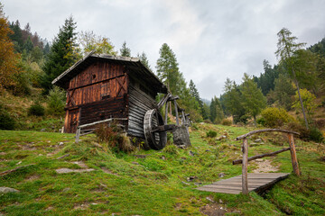 Old wooden water mill on a mountain near the place of Terenten in Puster Valley in South Tyrol, Italy