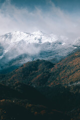 Obraz premium Clouds and snow on top of the mountain.