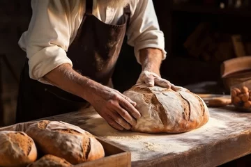 Foto op Plexiglas The baker placed a large loaf of bread hot from the oven on the wooden deck table. On a wood table, bread is sprinkled with flour and ready for sale. © omune