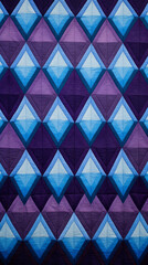 A pattern of purple and blue diamonds arranged in a quilt-like pattern