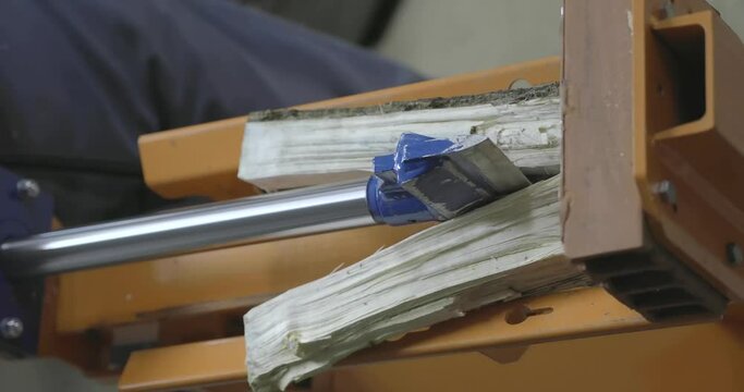 Hydraulic wood splitter cutting wood