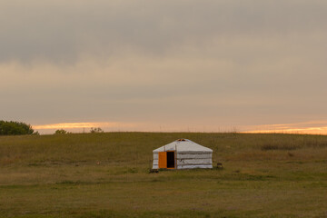 Single Traditional Nomadic House on Grassland Horizon at Sunset