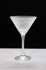 Crystal glass, without drink, on a black background on a marble table