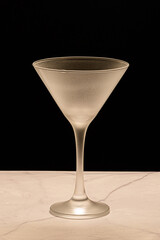 Crystal glass, without drink, on a black background on a marble table