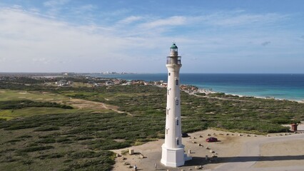 California Lighthouse with view of arid landscape, beach and seaside resorts in Aruba