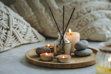 Burning candles, aroma fragrance natural organic diffuser, wooden bamboo tray. Concept of cozy home...