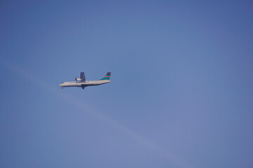 a plane flying against clear blue sky