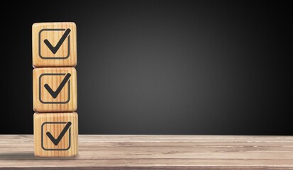 Check mark for jobs list on wooden blocks.