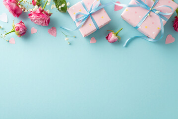 Valentine's Elegance: Top view arrangement with wrapped gifts, pink roses, gypsophila, and glittering heart confetti. Pastel blue background allows for text or advertising