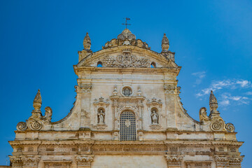 Fototapeta na wymiar Galatina, Lecce, Puglia, Italy. Ancient village in Salento. The wonderful Church of Saints Peter and Paul, in baroque style. Many marble statues and sculptures adorn the facade of the church.