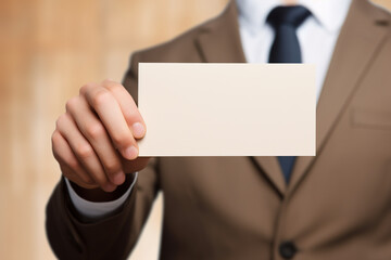 Close up of businessman hand holding blank advertising card, mock up