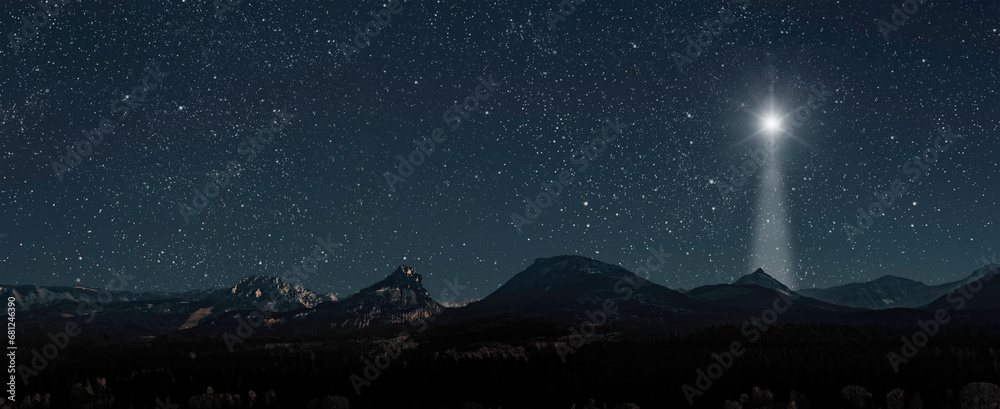 Wall mural christmas star shines at night over the mountains of bethlehem